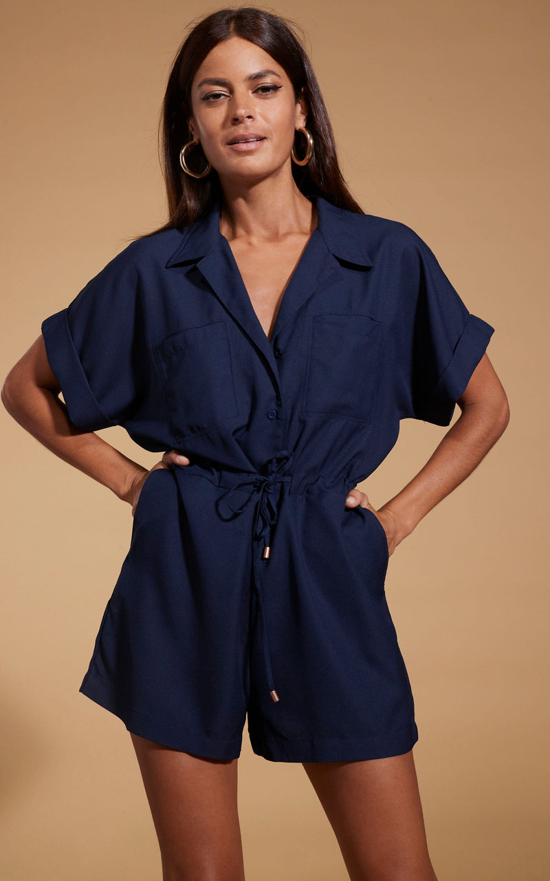 Dancing Leopard model wearing Rizzo Shirt Playsuit in Navy posed with hands in pockets