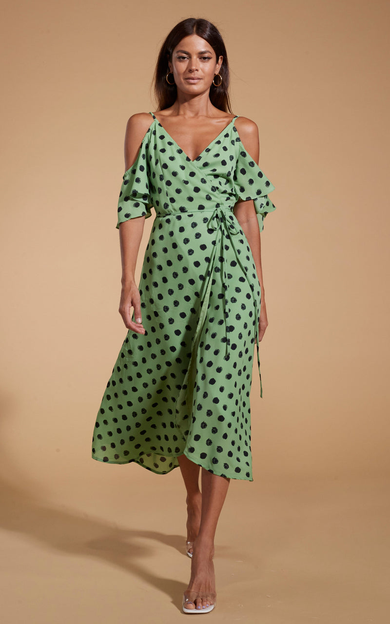 Dancing Leopard model wearing Ivy Dress Green Polka Dot walking towards shot