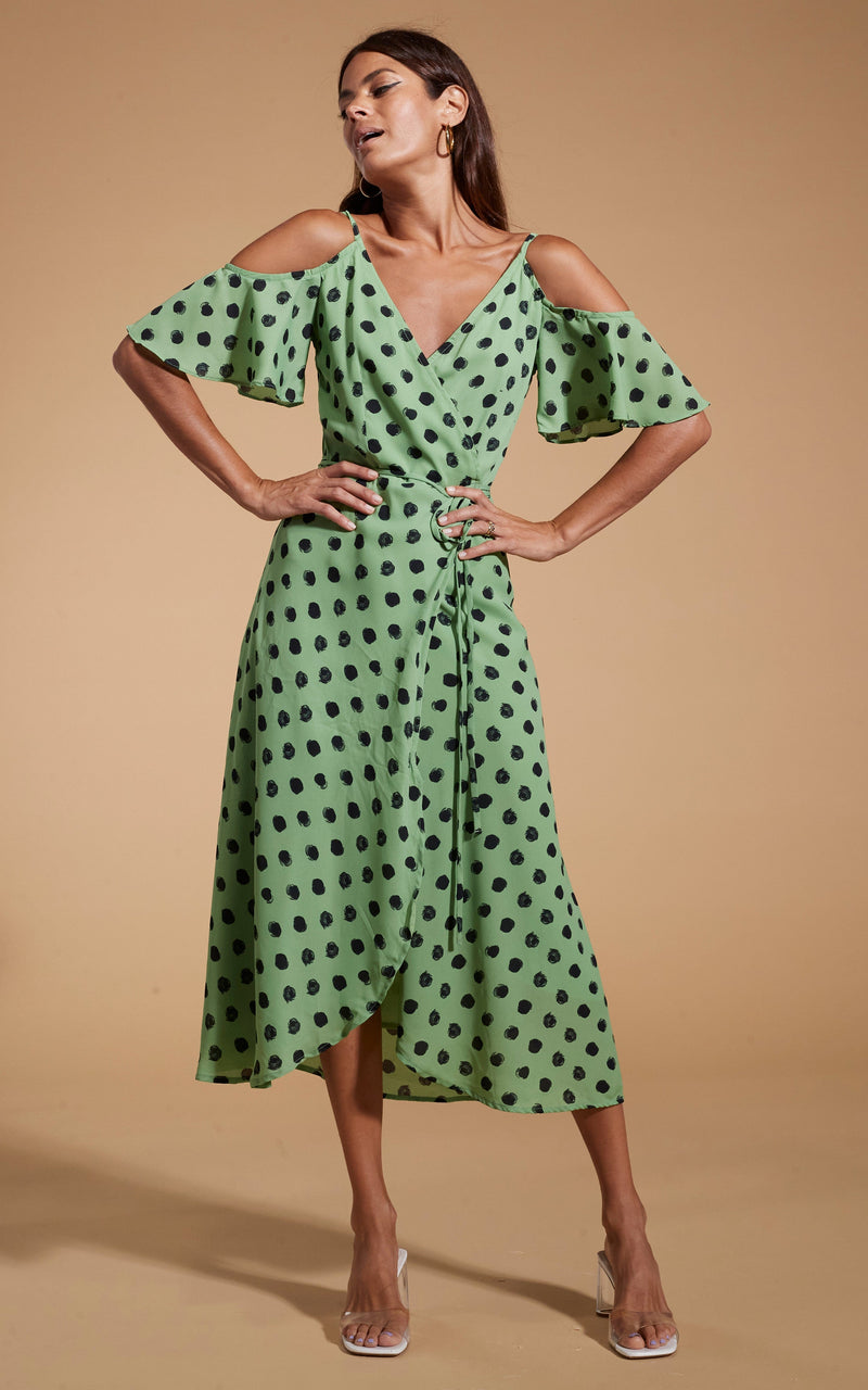 Dancing Leopard model wearing Ivy Dress Green Polka Dot posed with hands on hips