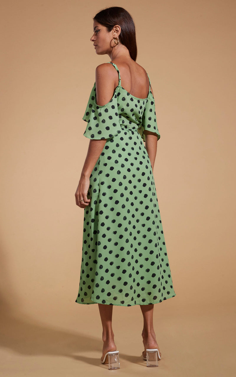 Dancing Leopard model wearing Ivy Dress Green Polka Dot facing away to reveal back of dress