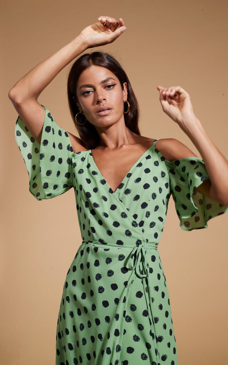 close up of Dancing Leopard model wearing Ivy Dress Green Polka Dot posed with arm above head