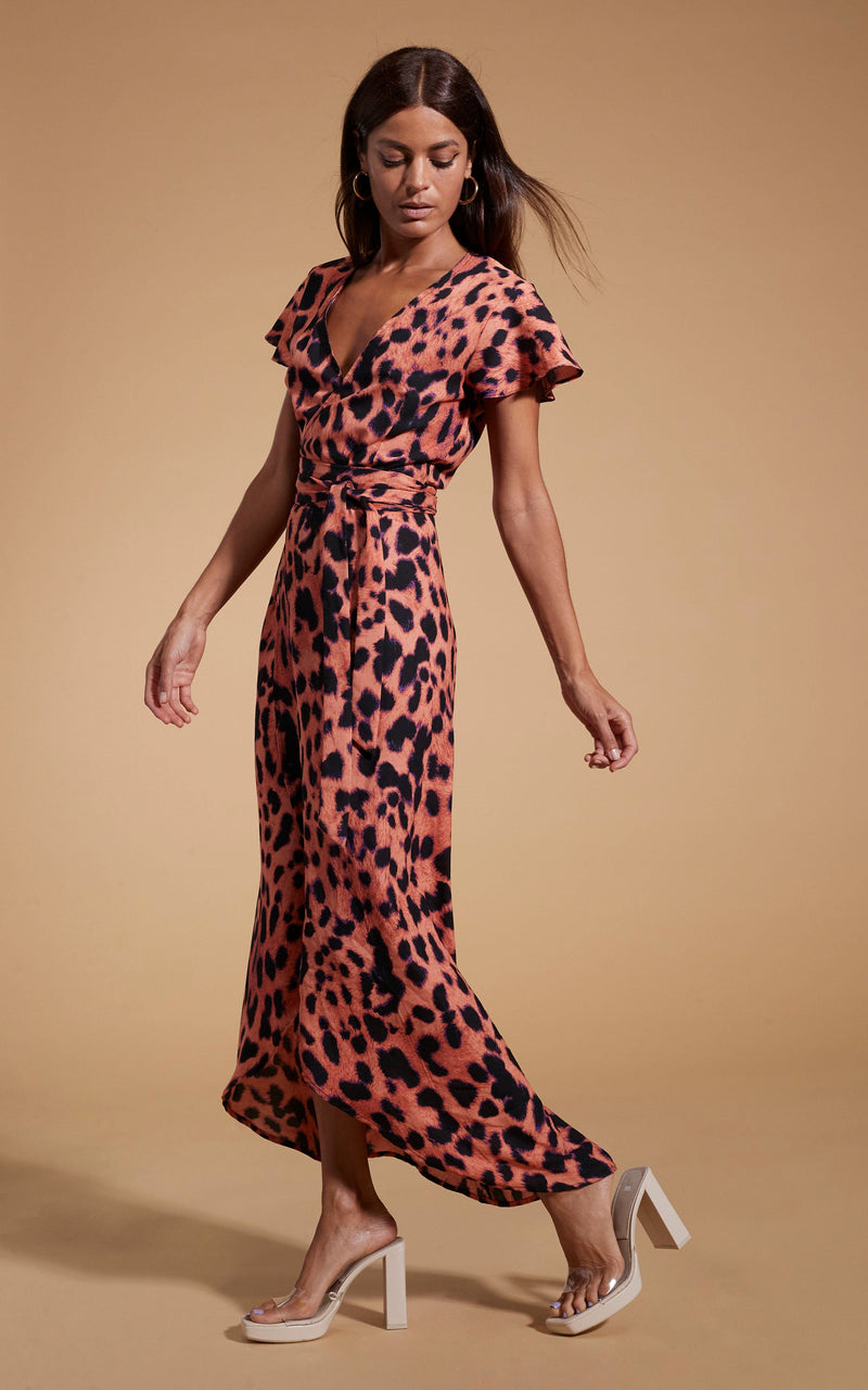 Dancing Leopard model wearing Cayenne Dress In Plorange Leopard walking from right to left