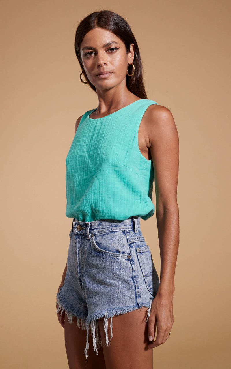 Dancing Leopard model wearing HALO Guava Twist Top in Mint Green facing side on