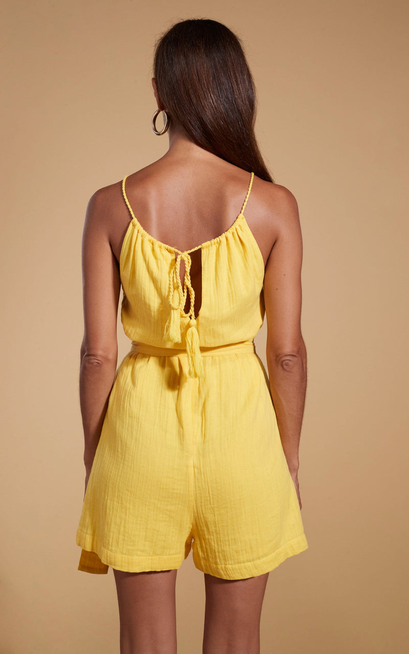 Dancing Leopard model wearing HALO Papillon Halter Neck Playsuit in Primrose Yellow facing away to show back of playsuit