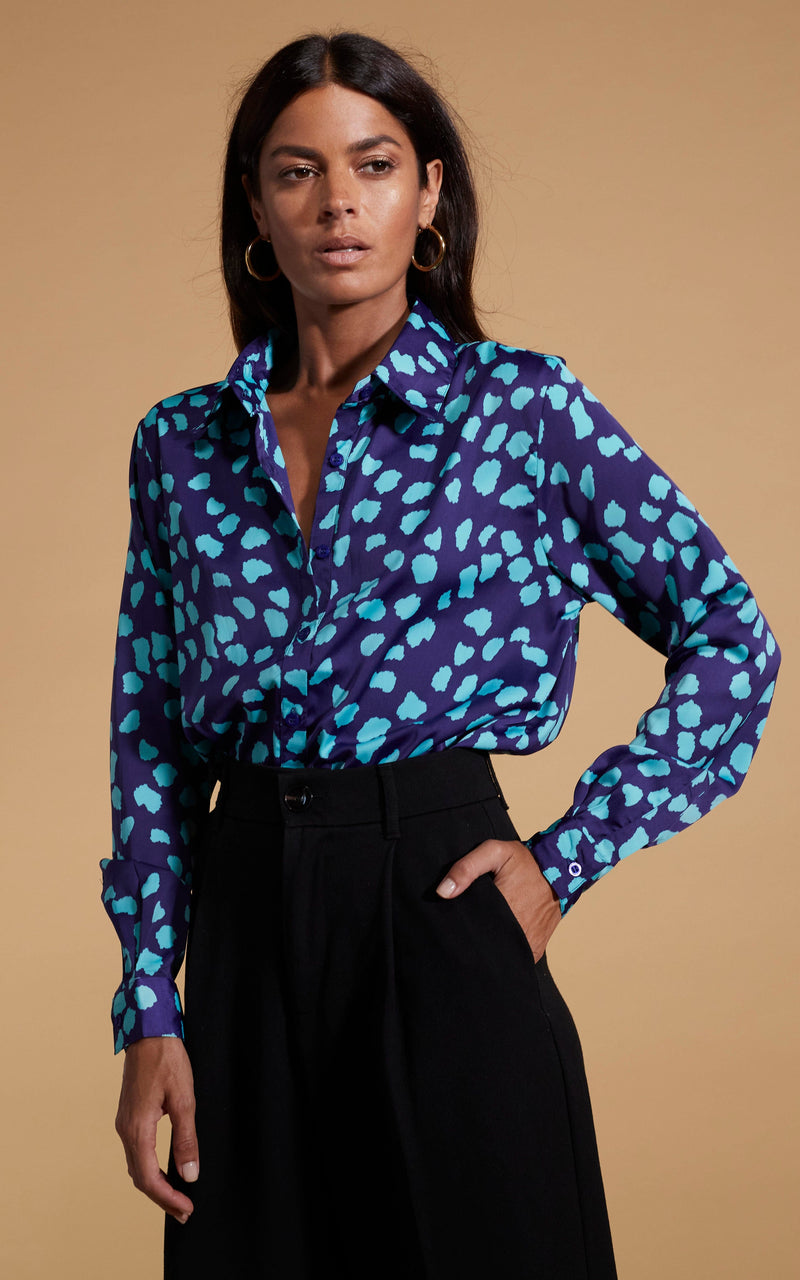 Dancing Leopard model wearing Nevada Satin Shirt In Ice Blue On Navy Cloud posed with hand in skirt pocket