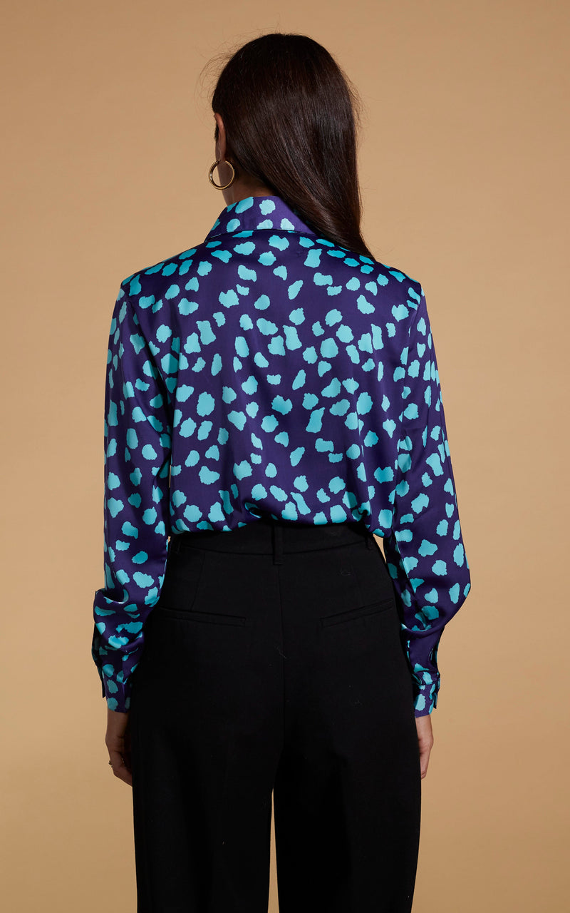 Dancing Leopard model wearing Nevada Satin Shirt In Ice Blue On Navy Cloud facing away to show back of dress