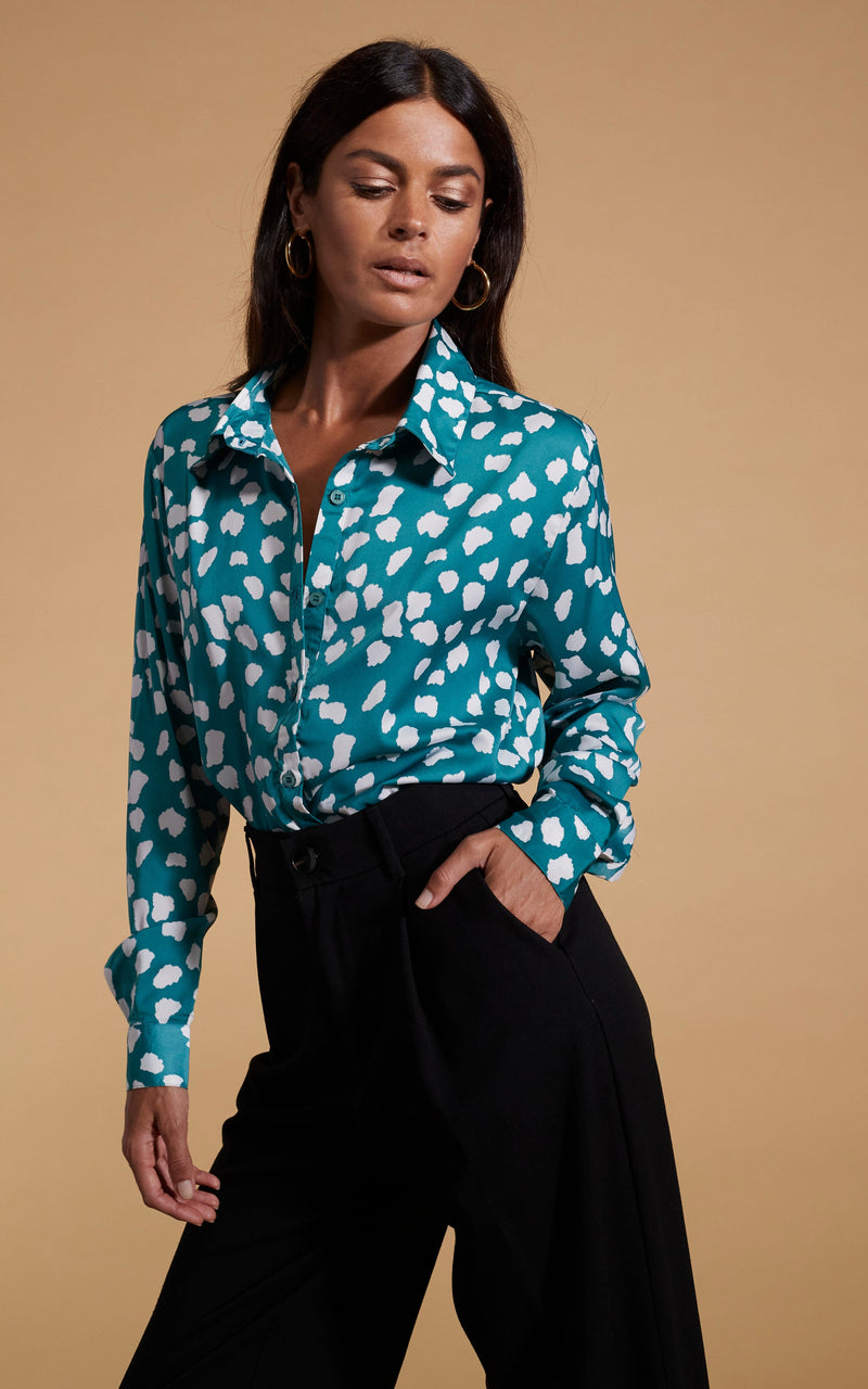 Dancing Leopard model wearing Nevada Satin Shirt In White On Green Cloud with black trousers