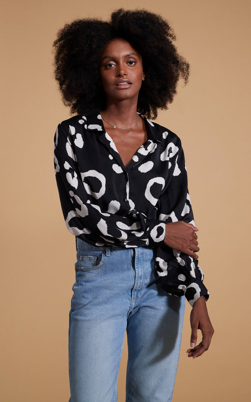 Dancing Leopard model wearing Dixie Balloon Sleeve Shirt In Oversized Mono Leopard posing by holding her arm