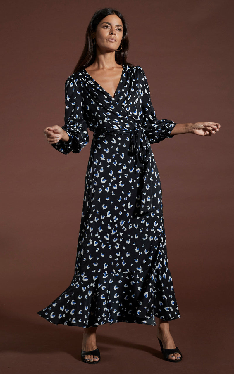 Dancing Leopard model wearing Havannah Maxi Wrap Dress in Abstract White on Black Leopard posed with arms out