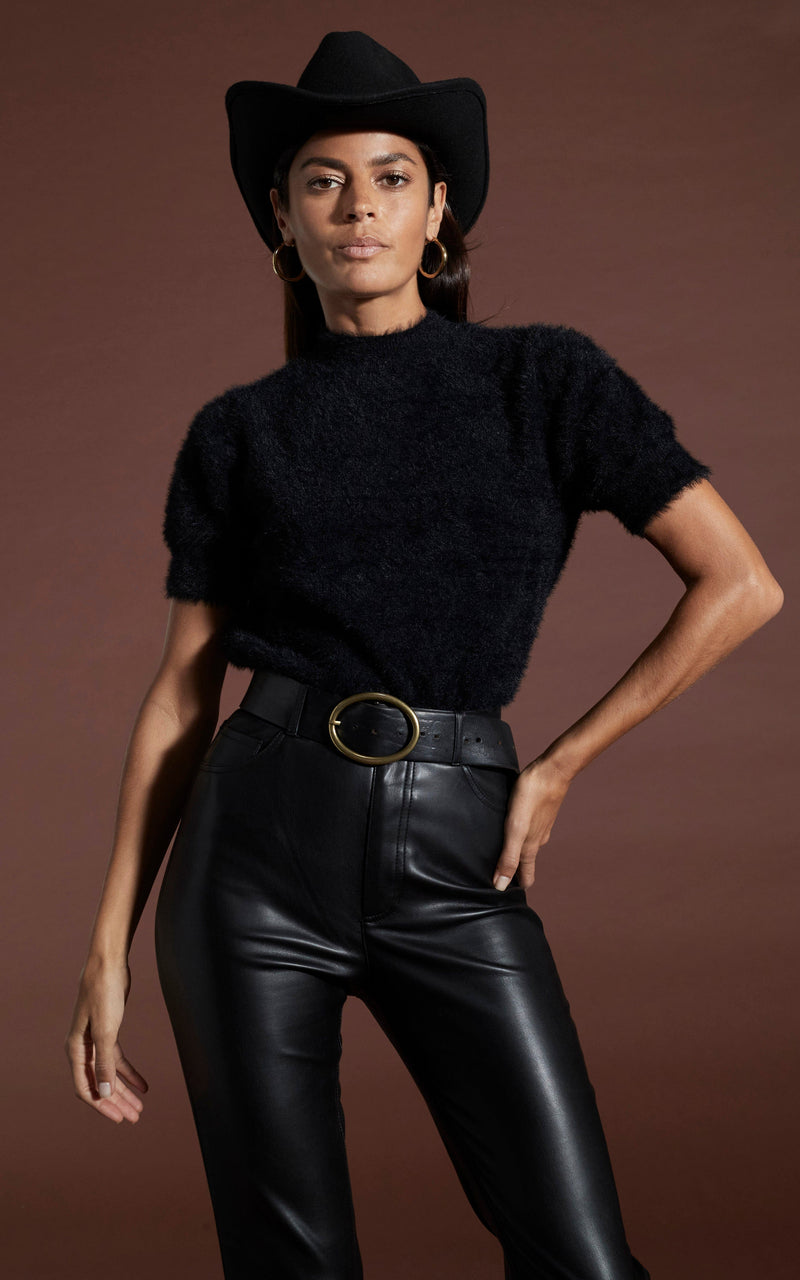 Dancing Leopard model wearing Millie Cropped Knit Top in Black with leather look trousers and hat