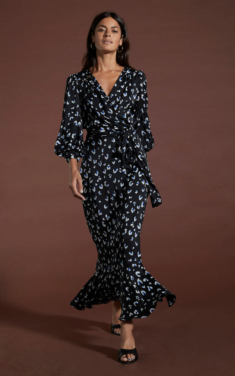 Dancing Leopard model wearing Havannah Maxi Wrap Dress in Abstract White on Black Leopard walking towards shot