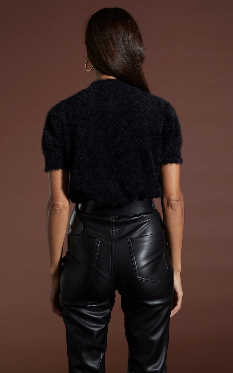 Dancing Leopard model wearing Millie Cropped Knit Top in Black facing away to show back of top