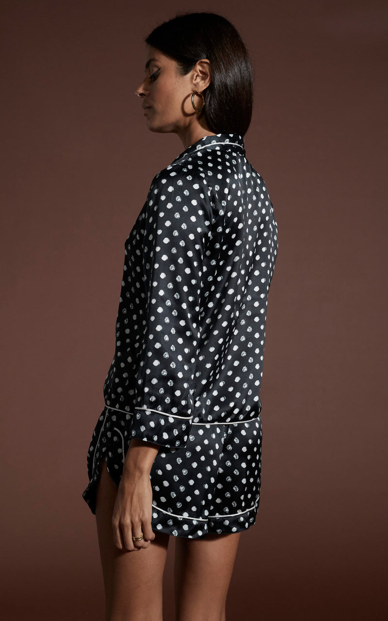 Dancing Leopard model wearing Oona Shortie PJ Set in Black Polka Dot facing away to show back of garment