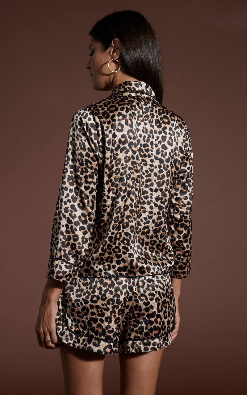 Dancing Leopard model wearing Oona Shortie PJ Set in Rich Leopard facing away to show back of pyjamas