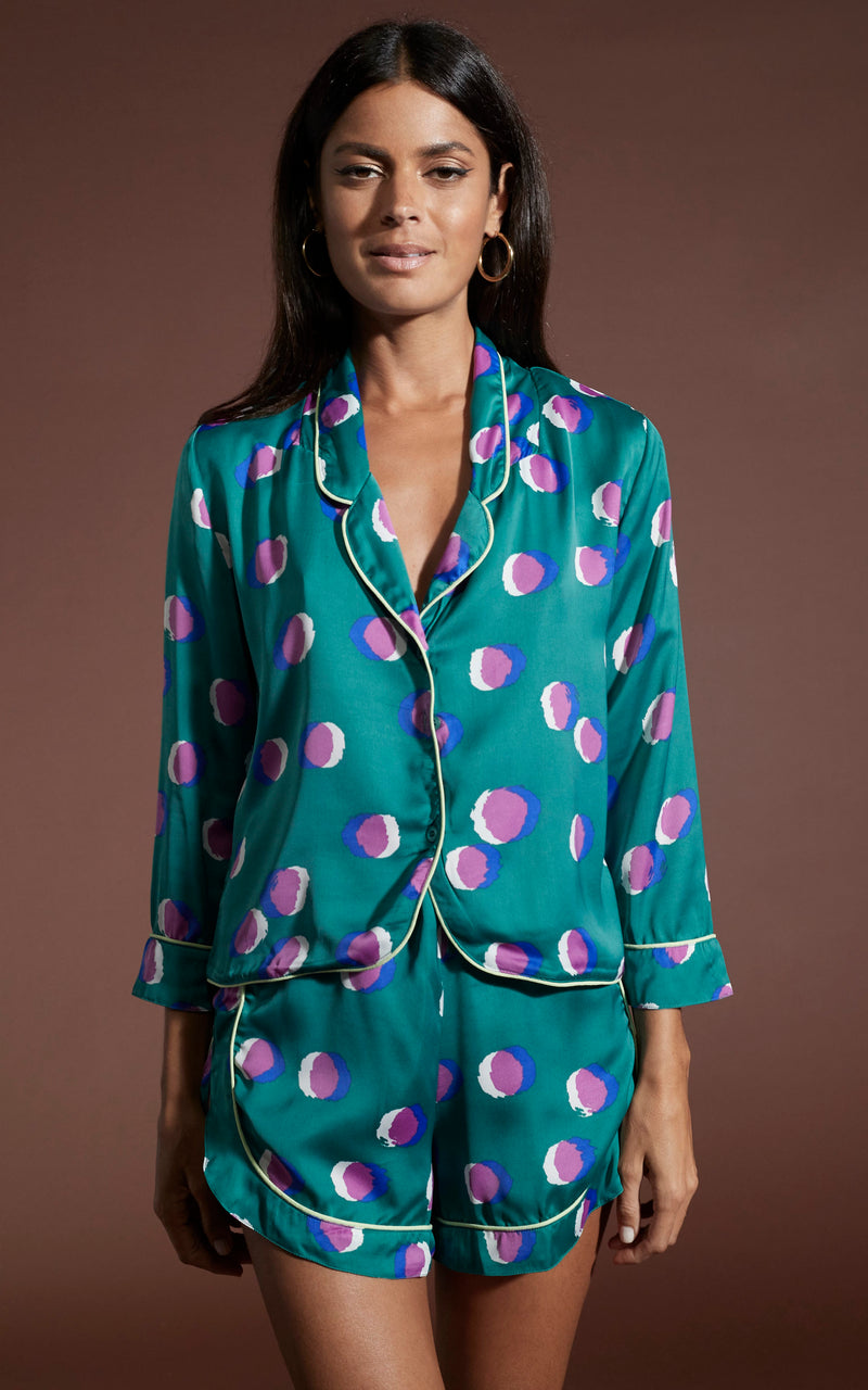 Dancing Leopard model wearing Oona Shortie PJ Set in Polka Dot Purple on Green