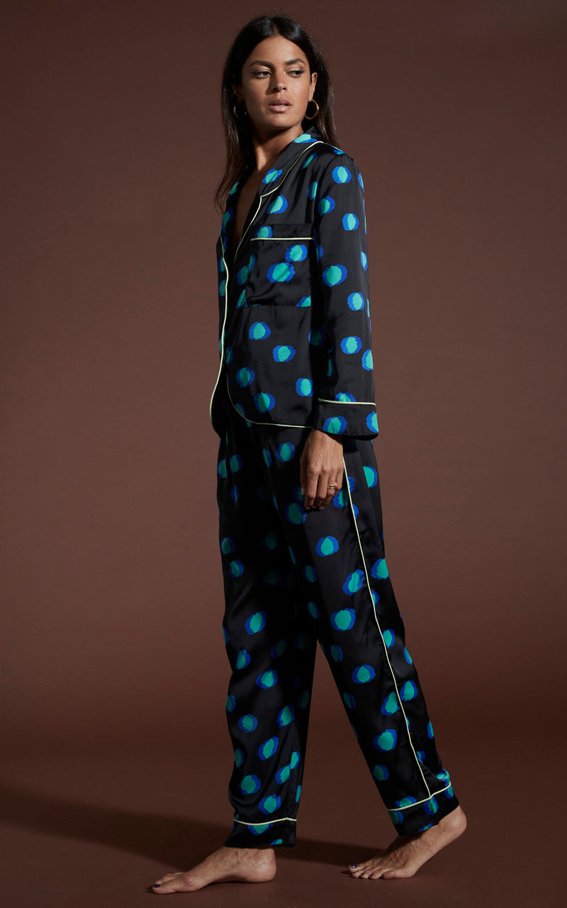 Dancing Leopard model wearing Cosmos Satin Long Leg PJ Set in Polka Dot Blue on Black walking from right to left