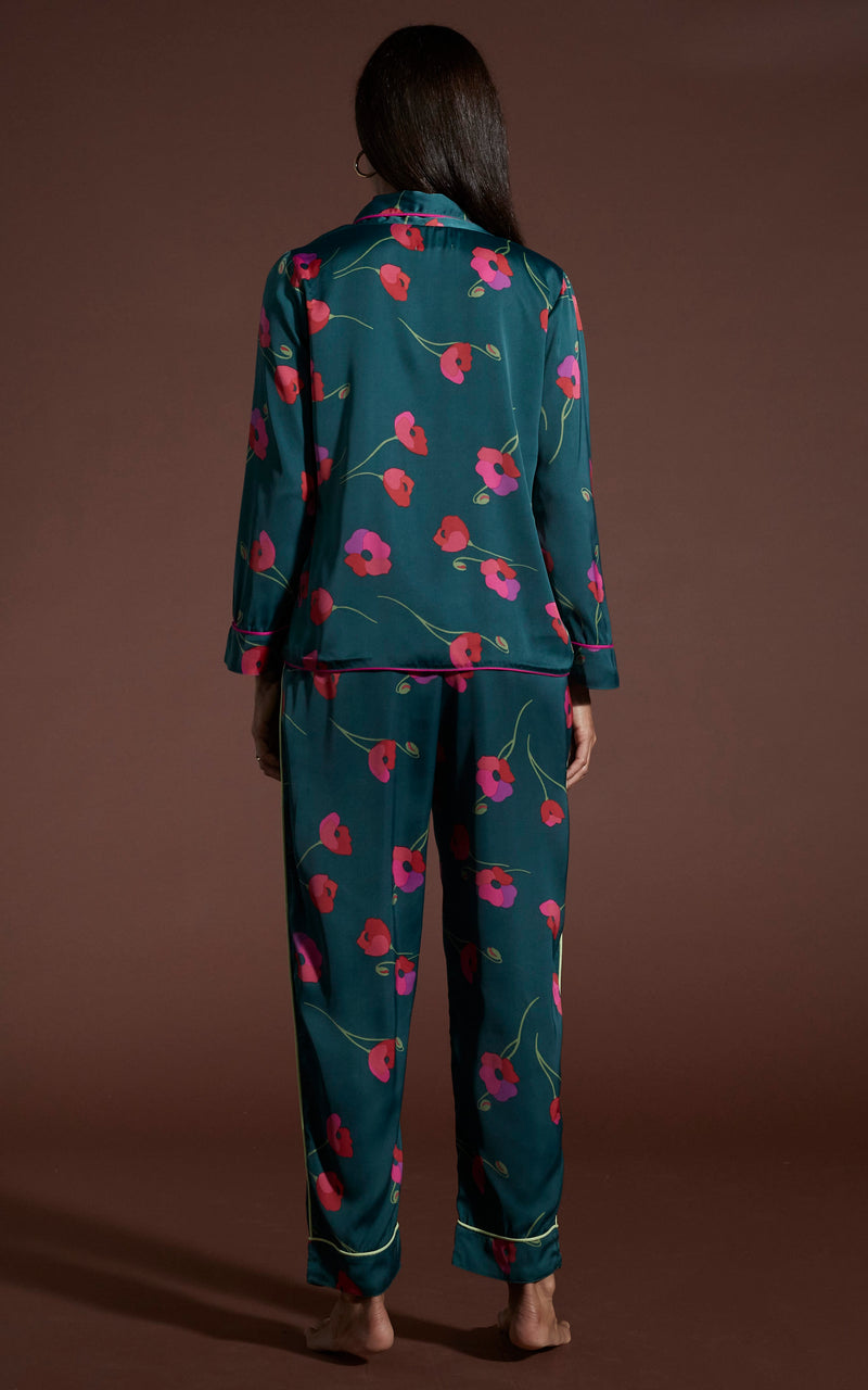 Dancing Leopard model wearing Cosmos Satin Long Leg PJ Set in Poppies on Dark Green facing away to reveal back details