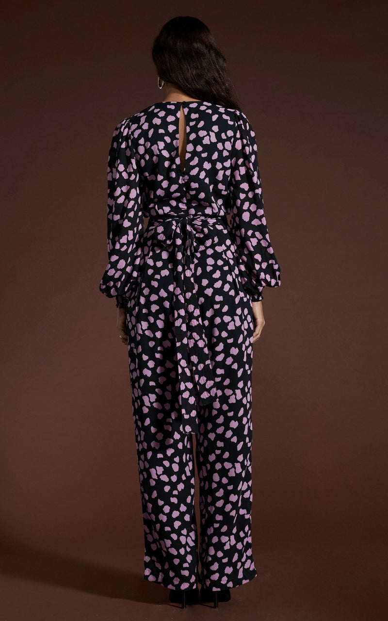 Dancing Leopard model wearing Holly Jumpsuit In Pink On Black Cloud posed facing away to reveal back of jumpsuit