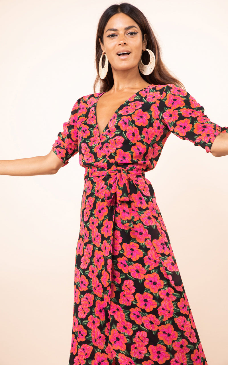 Dancing Leopard model faces forwards with arms open wearing Olivera Midi Dress in pink floral print