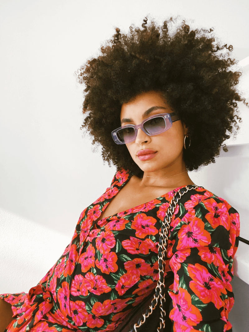 Model wears dancing leopard hibiscus olivera midi dress with sunglasses