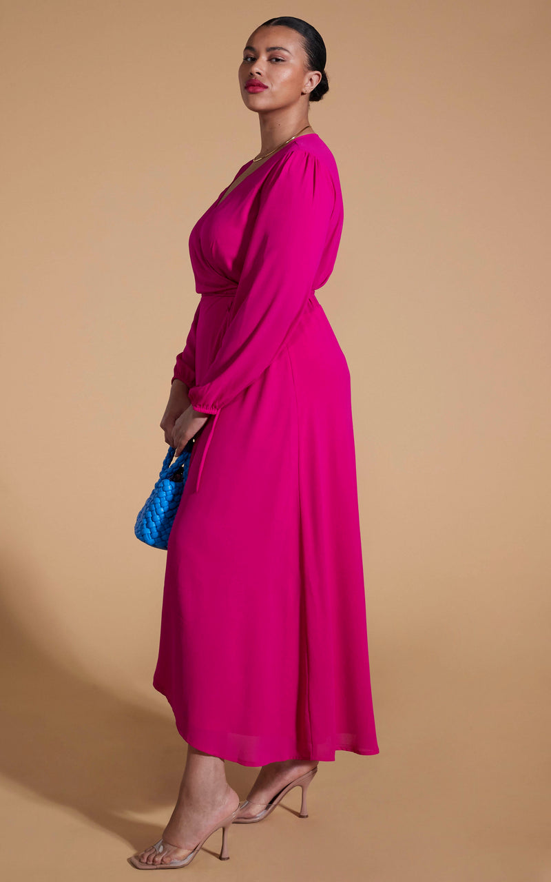 Dancing Leopard model wearing Jagger Maxi Dress In Magenta facing side on holding blue handbag