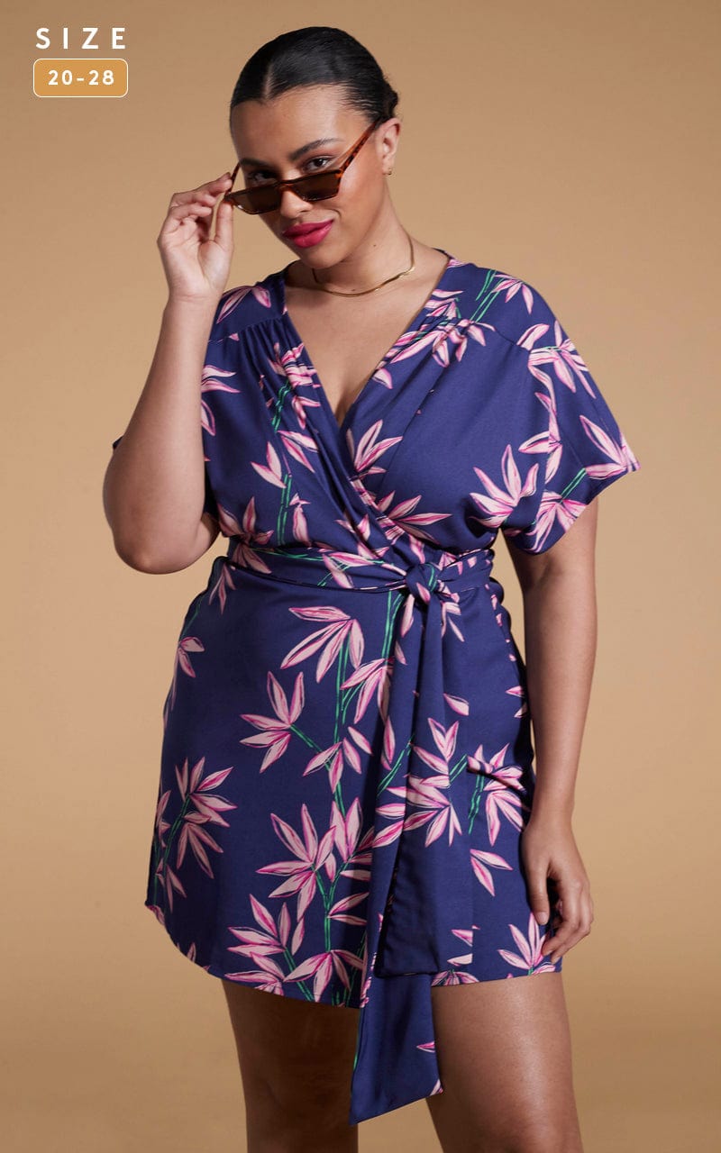 Dancing Leopard model wearing Kansas Mini Wrap Dress In Bamboo Navy Base posing looking over sunglasses