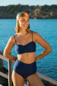 Dancing Leopard model wearing HALO Lalita Bandeau Bikini Top In Navy posing on waters edge