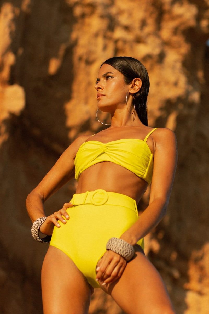 Dancing Leopard model faces forward wearing Lalita Bikini Top and Juniper Bottoms while standing on beach