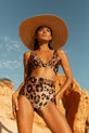 Dancing Leopard model faces forward and stands on beach wearing HALO Juniper bikini brief and Tamika bikini top in leopard print