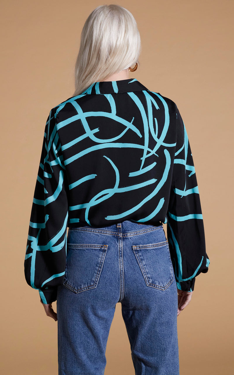 Dancing Leopard model wearing Dixie Balloon Sleeve Shirt In Blue Strokes On Black facing away to reveal back details