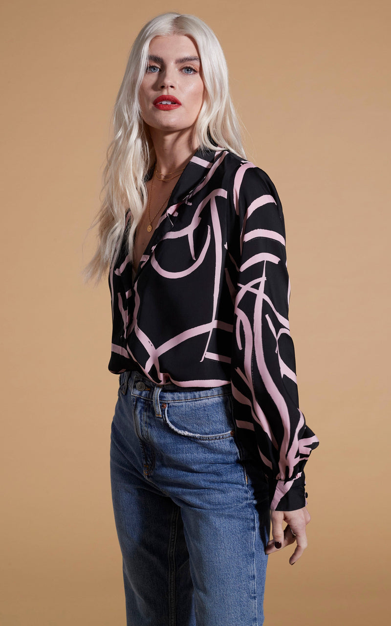 Dancing Leopard model wearing Dixie Balloon Sleeve Shirt In Pink Strokes On Black facing side on