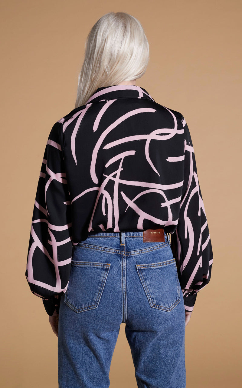Dancing Leopard model wearing Dixie Balloon Sleeve Shirt In Pink Strokes On Black facing away to reveal back details