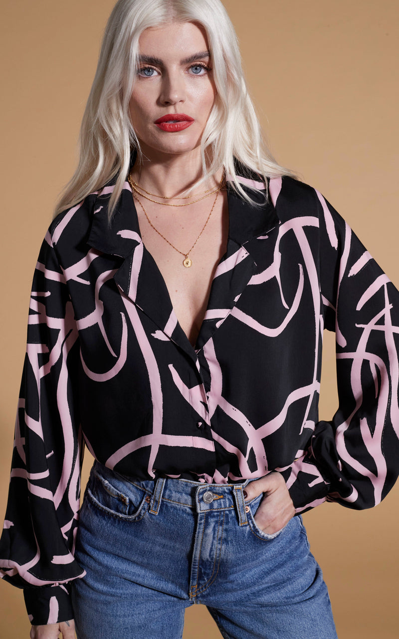 close up of Dancing Leopard model wearing Dixie Balloon Sleeve Shirt In Pink Strokes On Black