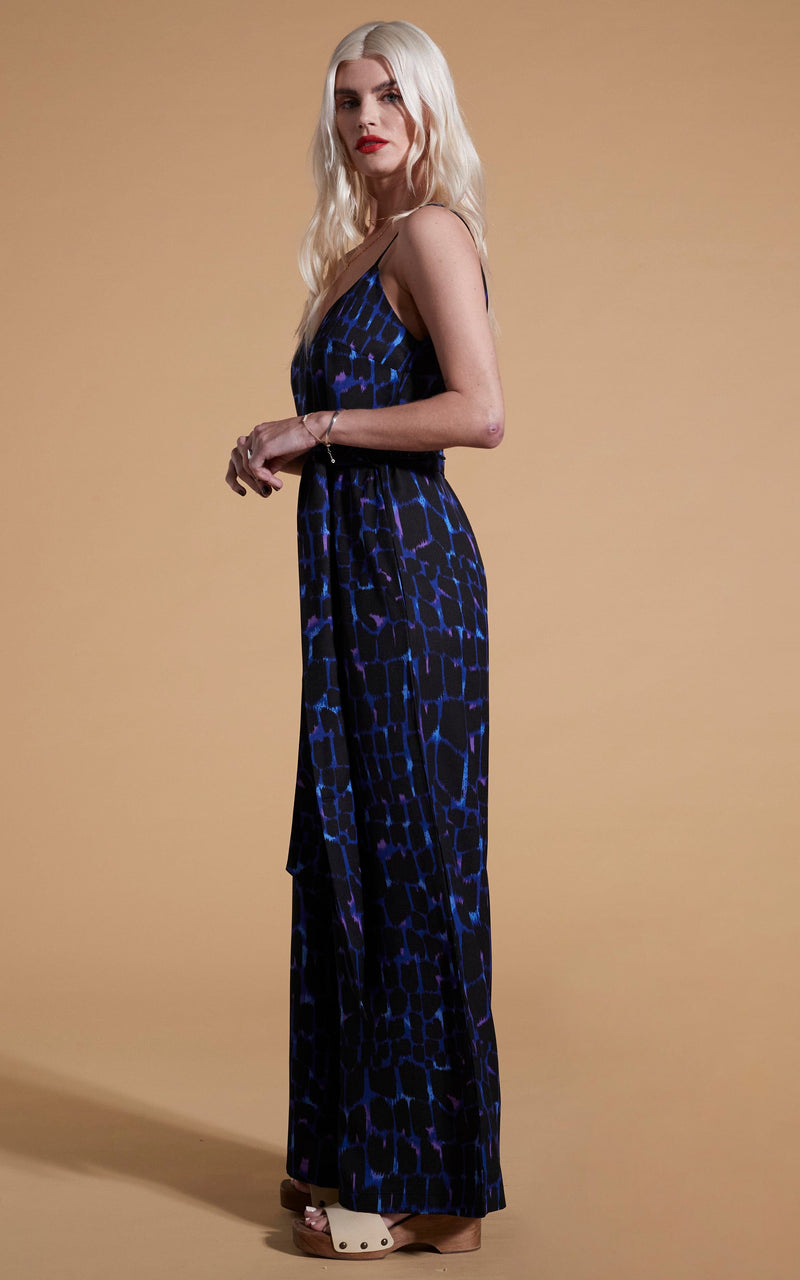 Dancing Leopard model wearing Gabriella Jumpsuit In Blue Alligator facing side on
