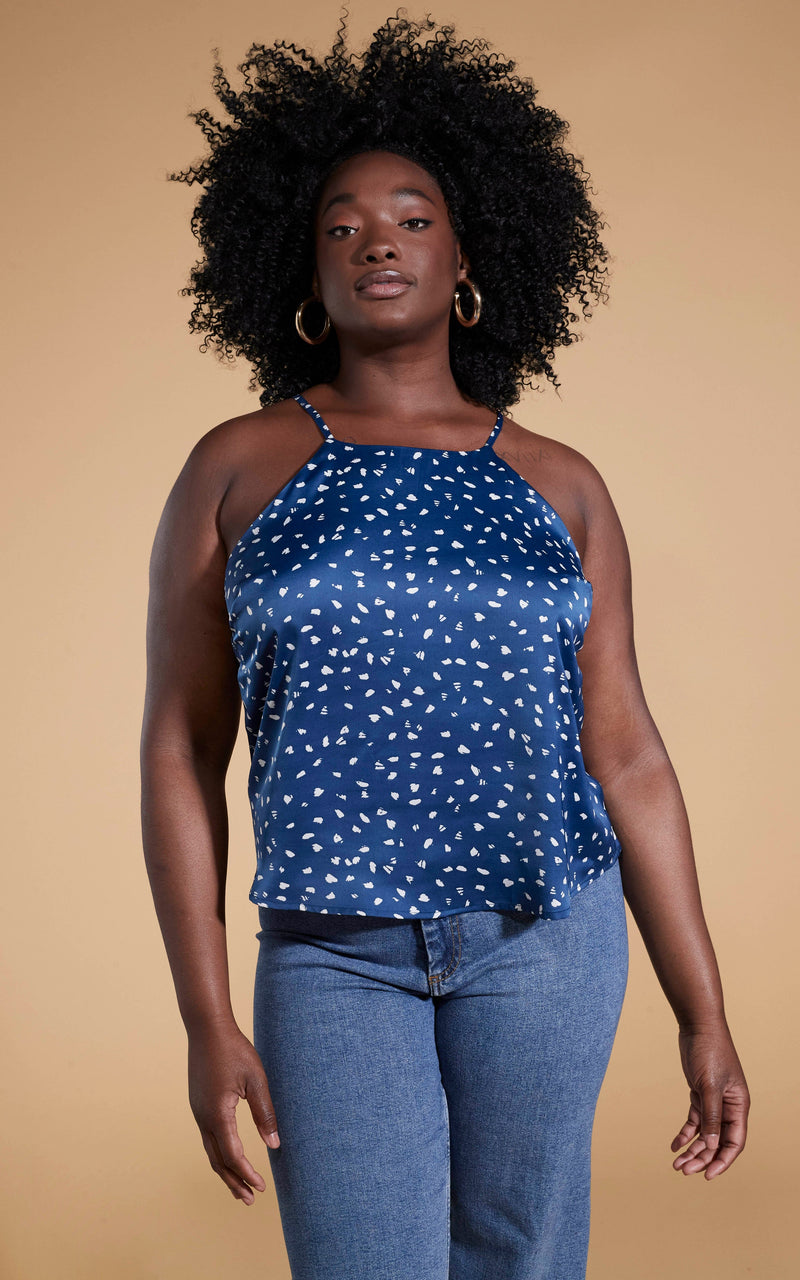 Dancing Leopard model standing with hands in blue jeans wearing Nina halter cami top in abstract white on navy