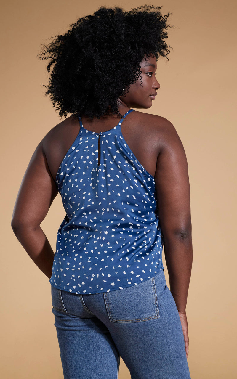 Dancing Leopard model standing with her back to the camera wearing Nina halter cami top in abstract white on navy with blue denim jeans