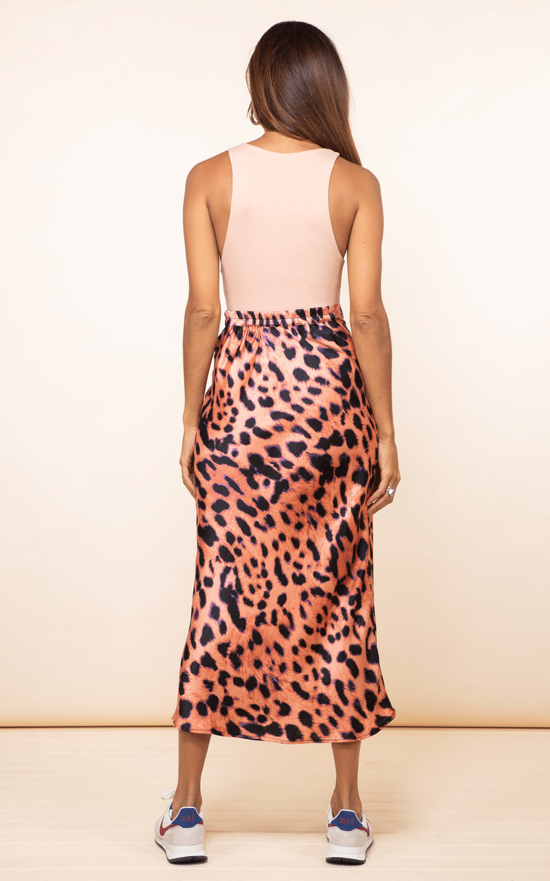 Dancing Leopard model faces backwards wearing Renzo Skirt in leopard print