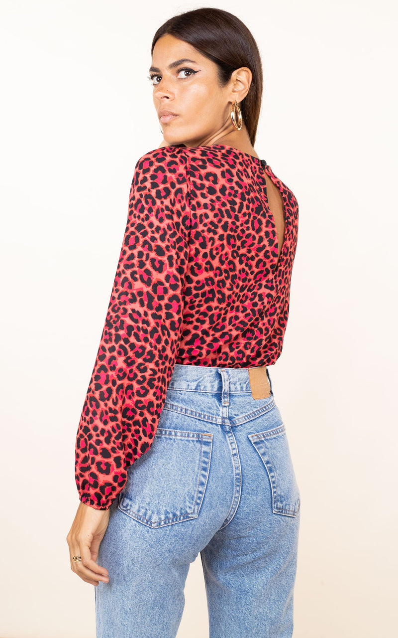 Dancing Leopard model faces backwards wears Bixby Bodysuit In Ruby Red Leopard print
