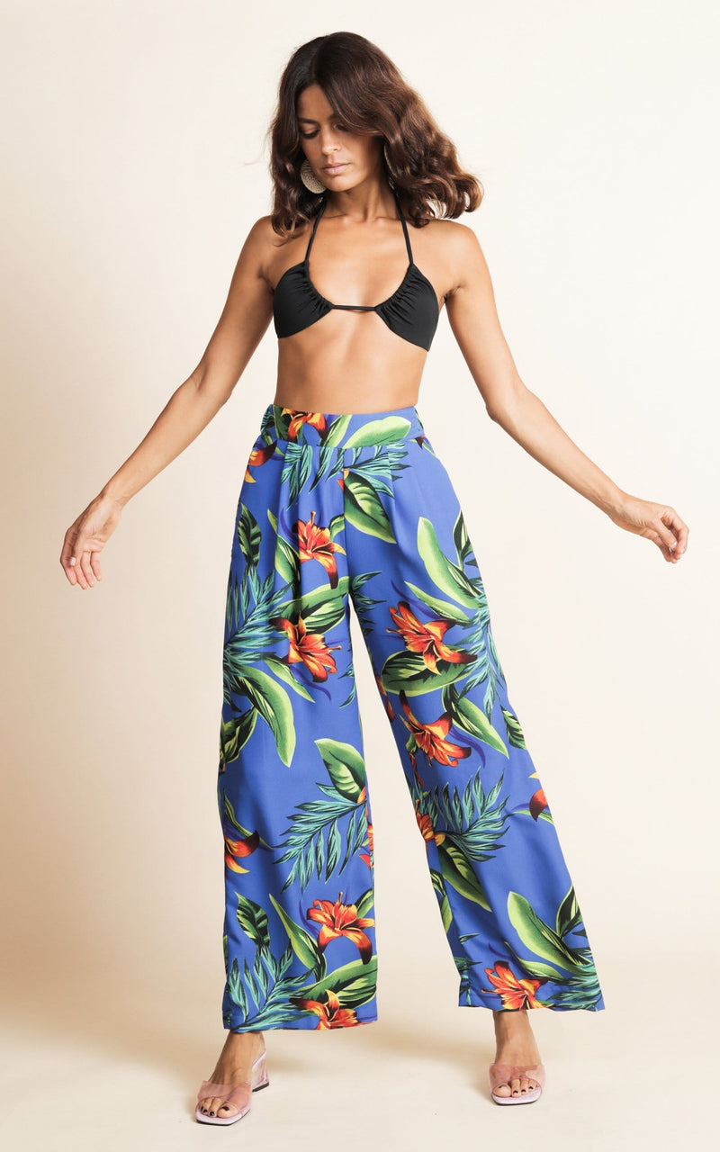 Dancing Leopard model wearing Joey Palazzo Trousers in Blue Tropical posed with arms flared out