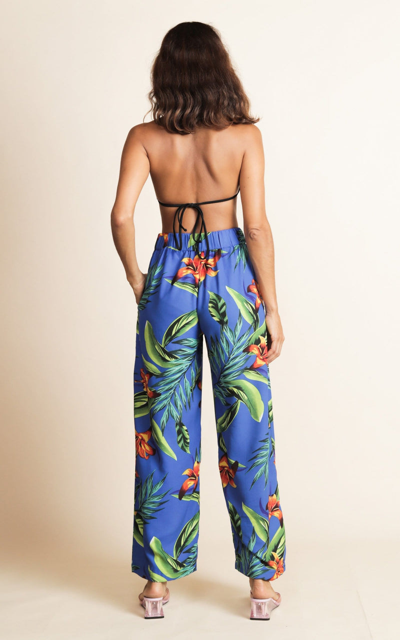 Dancing Leopard model wearing Joey Palazzo Trousers in Blue Tropical facing away to reveal back details