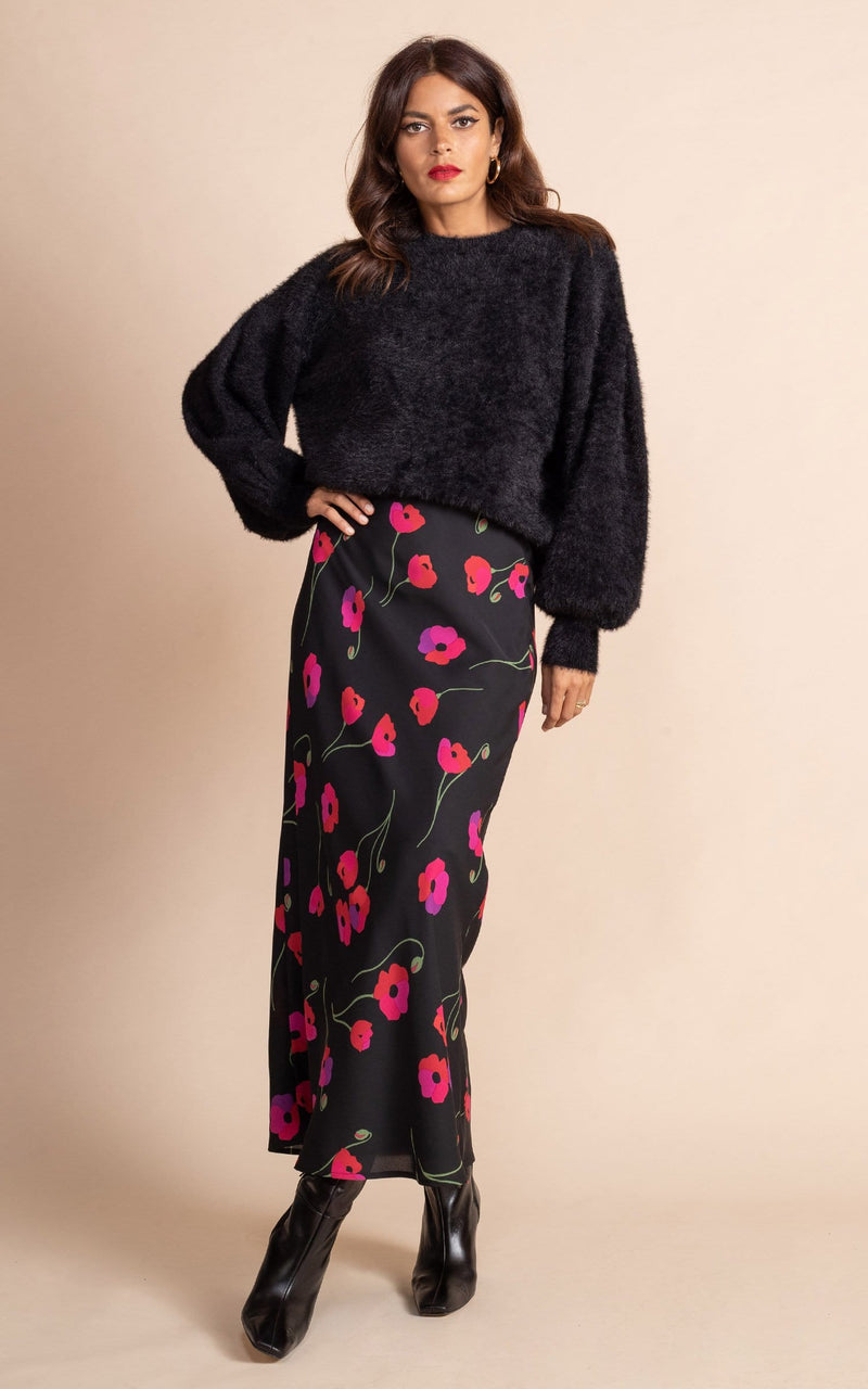 Dancing Leopard model wearing black furry jumper and black and red / pink poppies floral design slip skirt with black boots