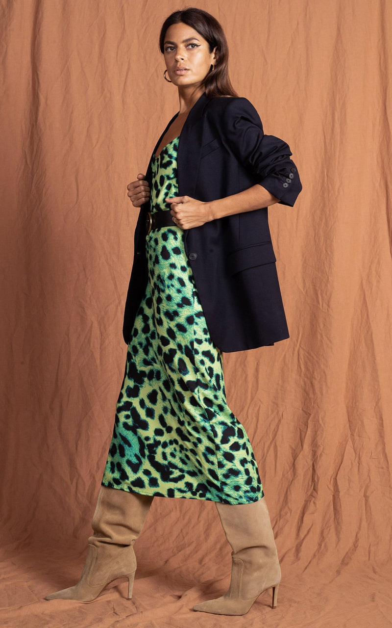 Dancing Leopard model faces sideways wearing Sienna Midaxi in Lime Leopard Print with heels, belt and black blazer