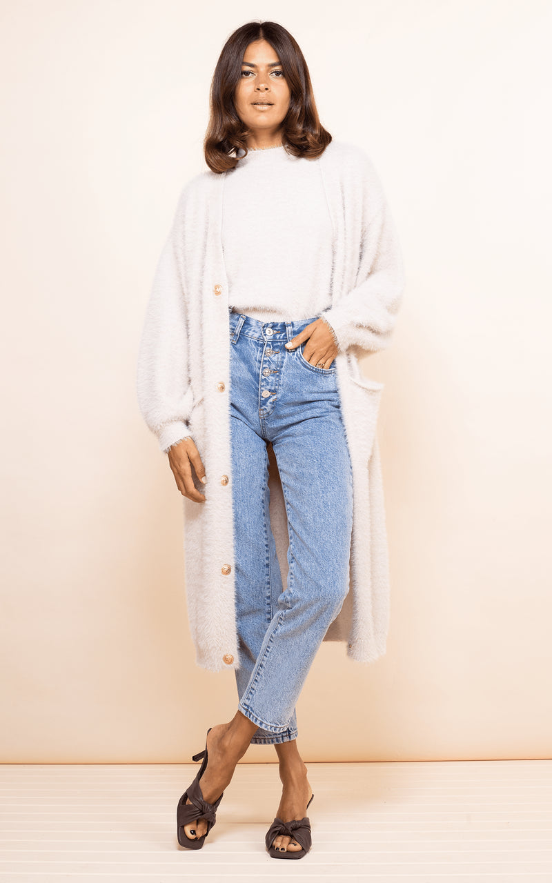 Dancing Leopard model faces forwards wearing Taylor Cardigan in nude with jeans