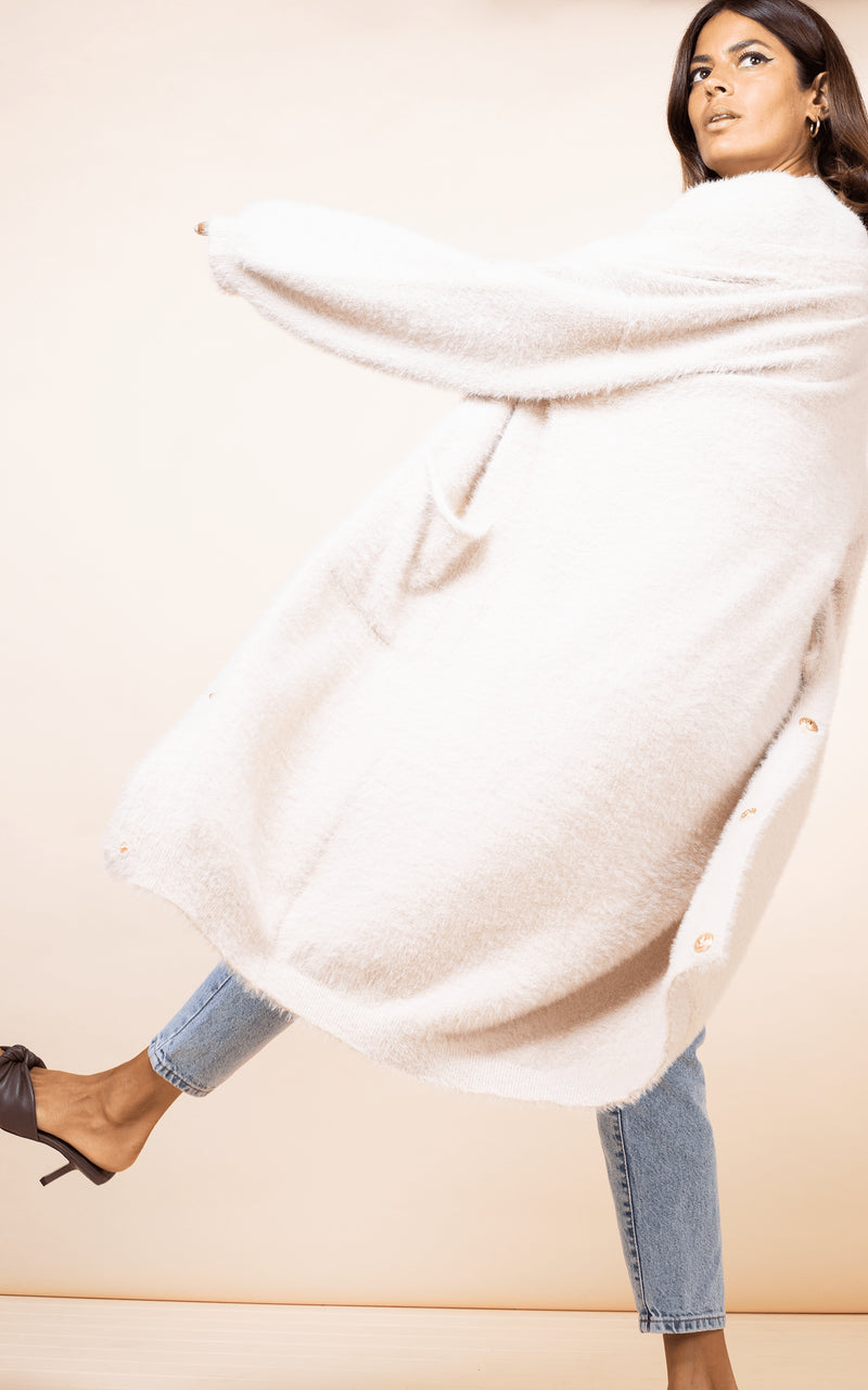 Dancing Leopard model spins around wearing Taylor Cardigan in nude with jeans
