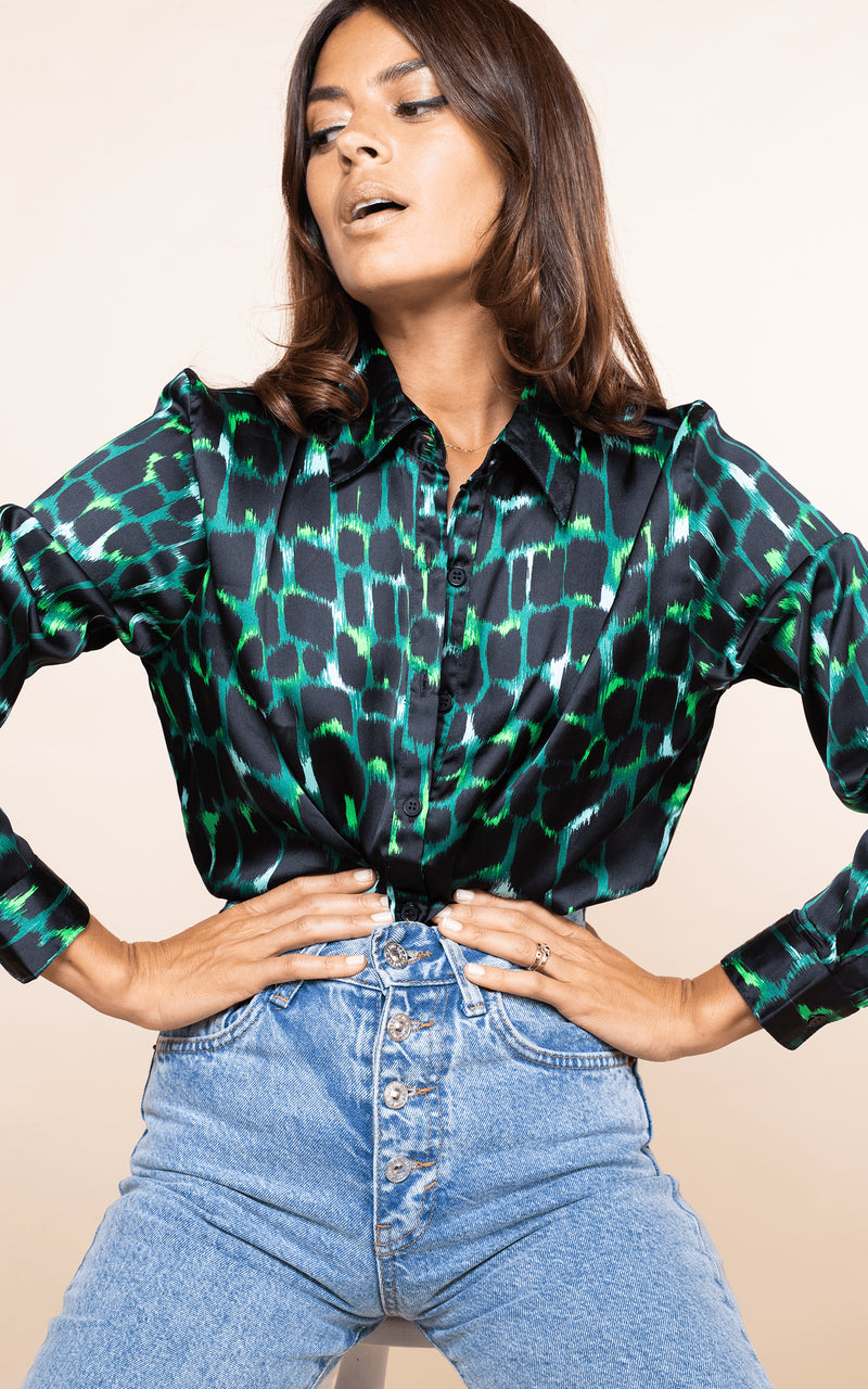 Dancing Leopard model faces forward with hands on hips wearing San Diego Shirt in green alligator with jeans