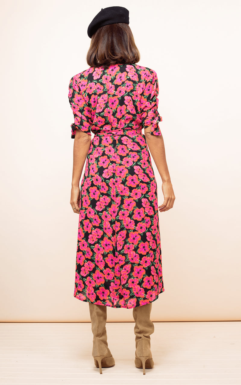 Dancing Leopard model wearing Olivera Midi Dress in Hibiscus Pink on Black facing away to show back of dress