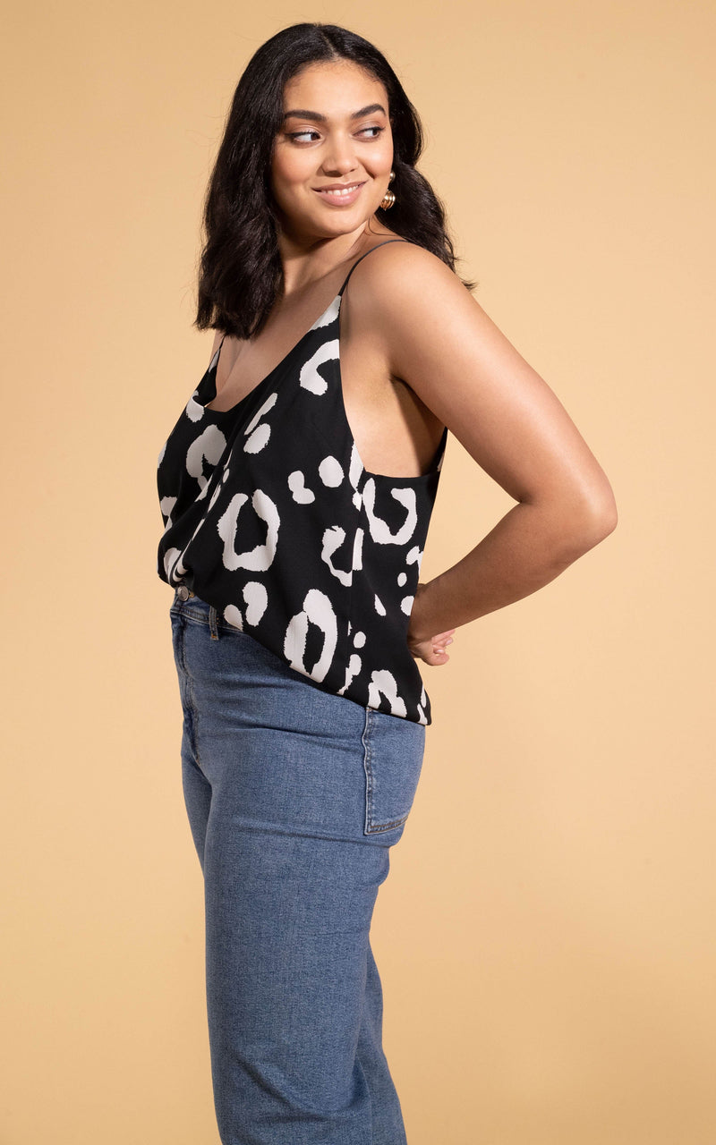 Dancing Leopard model wearing Birdie Cami Top in Oversized Mono Leopard posed looking over shoulder 