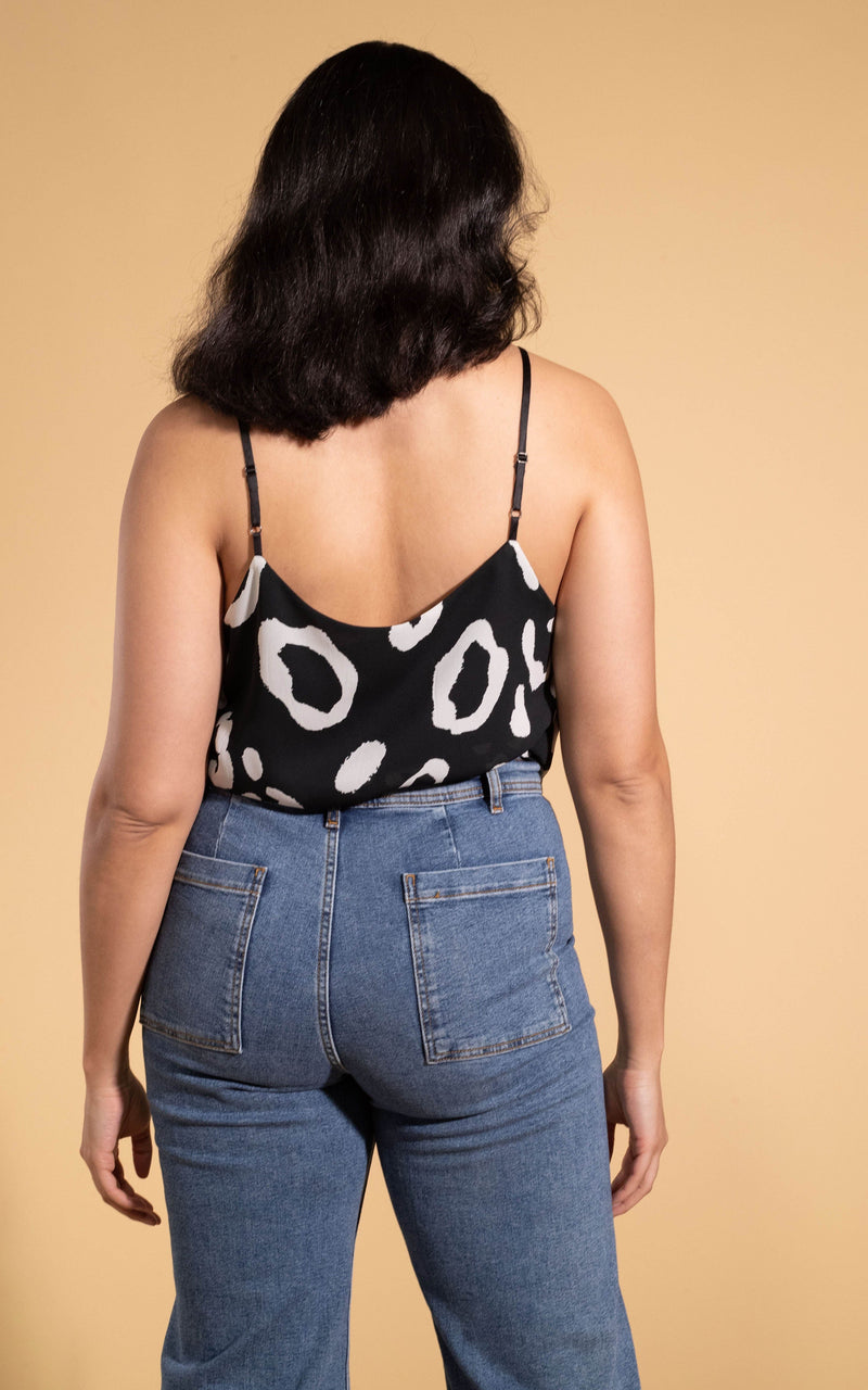 Dancing Leopard model wearing Birdie Cami Top in Oversized Mono Leopard facing away to reveal back details