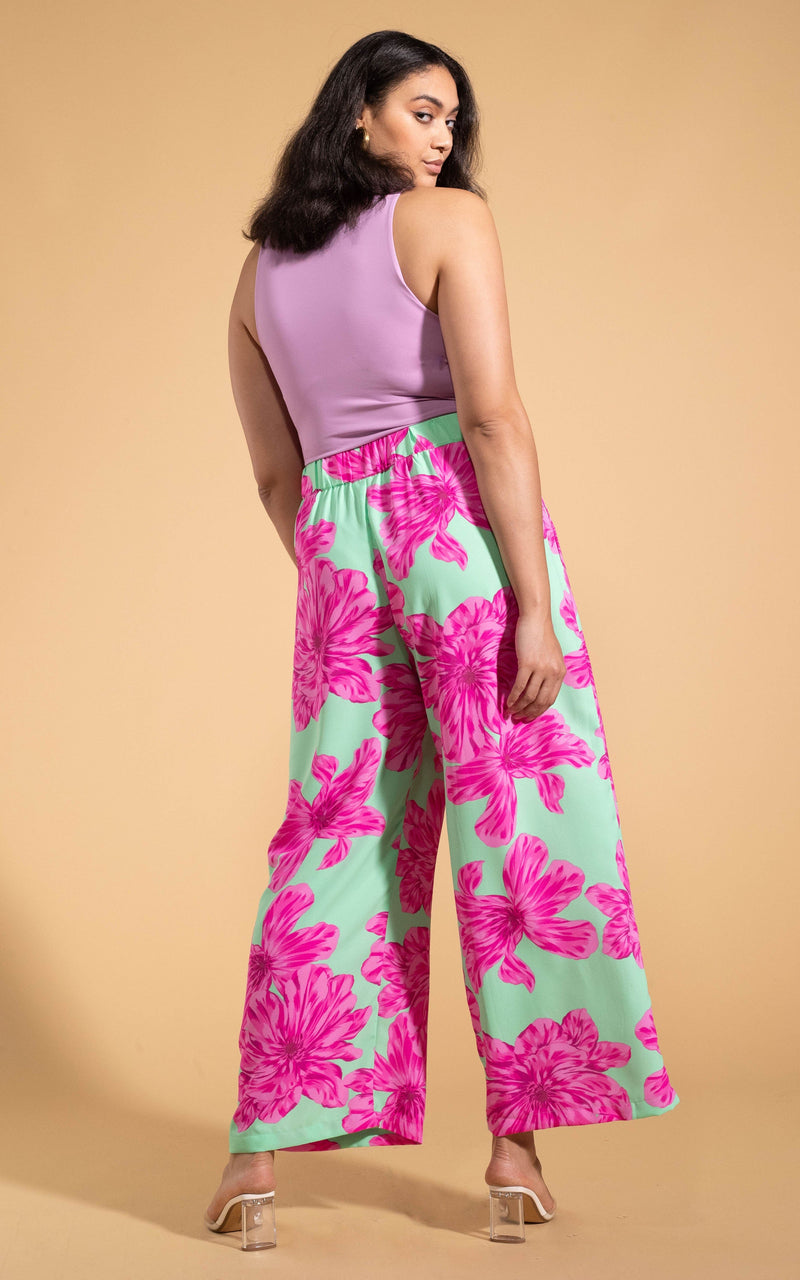 Dancing Leopard model wearing Joey Palazzo Trousers in Pink on Mint Bloom facing away to show back of trousers