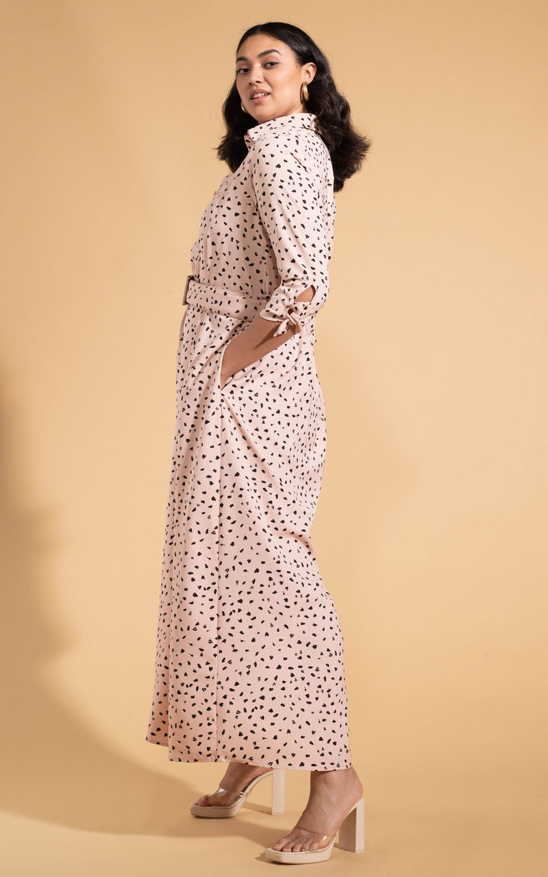Dancing Leopard model wearing Dove Dress in Abstract Black on Beige facing side on with hand in pocket